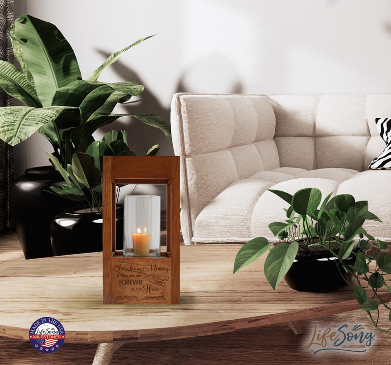 May include: A wooden candle holder with a glass cylinder for a candle. The holder has an engraved message that reads "In Loving Memory of Those who are FOREVER in our Hearts".