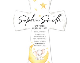 May include: A white wooden cross with the name "Sophia Smith" and the date "April 16, 2023" printed on it. The cross features a watercolor illustration of a baby elephant on a crescent moon, surrounded by stars. The text "Baptized" is also included.