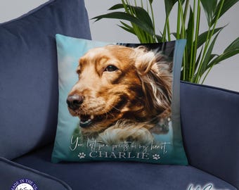 May include: A blue and white throw pillow with a photo of a golden retriever dog. The text "You left paw prints on my heart, CHARLIE" is printed on the pillow.