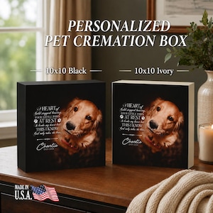 May include: Two square pet cremation boxes, one black and one ivory, each featuring a printed golden retriever portrait and the text: A HEART of Gold stopped beating, FOUR LITTLE PAWS AT REST, It broke my heart but THIS I KNOW God only takes the best, Charlie 2015-2021.