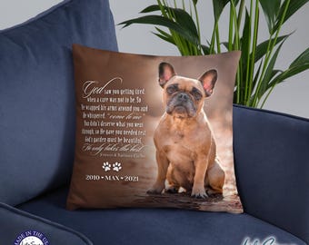 May include: Brown square throw pillow featuring a French Bulldog. The pillow has a memorial poem and the text "God saw you getting tired." Includes the years 2010-2021 and paw prints. The pillow is on a blue surface.