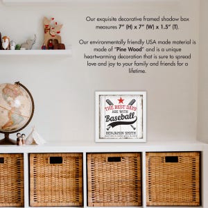 May include: A white framed shadow box with a red star and the text "The Best Days Are With Baseball" in black. The name "Benjamin Smith" and the date "Baptized in Christ April 20" are also included in black text. The shadow box measures 7 inches high by 7 inches wide by 1.5 inches deep.
