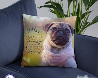 May include: A beige and brown throw pillow with a photo of a pug wearing a pink sweater. The pillow has the text "Max, A Memory is a Beautiful Joy That Lives Forever in Your Heart" printed on it.
