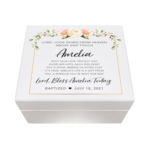 May include: A white box with a gold border and floral design. The text reads "Lord, look down from heaven above and touch Amelia with your love. Protect and guide her until each and every day is done. Remind us often that it's true; Amelia's life is a gift from you. A miracle you've sent our way. Lord, Bless Amelia Today. Baptized July 18, 2021"