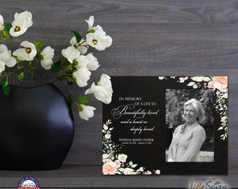 May include: Black picture frame with a floral design and a black and white photo of a woman. The frame has the text "In memory of a life so beautifully lived and a heart so deeply loved." and "Patricia Renee Cooper October 12, 1912 - January 1, 2018".