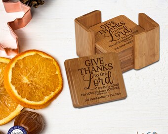 May include: Set of six bamboo coasters with a holder. The coasters feature a laser-engraved design with the text "Give Thanks to the Lord" and a Bible verse. The coasters are personalized with the text "The Avina Family Est. 2020".