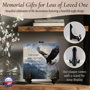 May include: Square memorial plaque with an eagle design, mountains, and text. The plaque includes the text "The Lord Will Renew Strength, They Will Soar On Wings Like Eagles." It comes with a stand for display. The plaque is made in the USA.