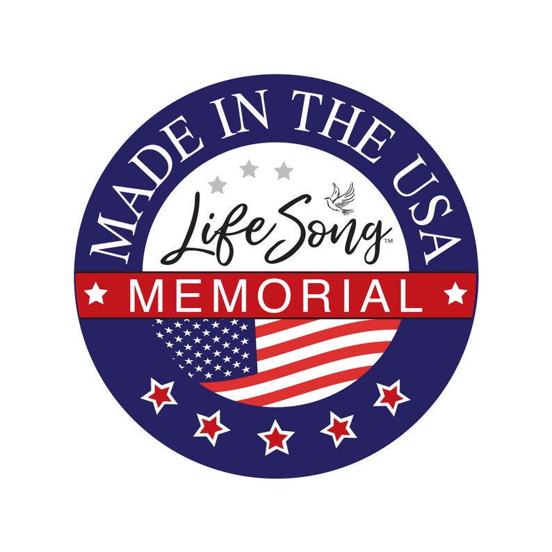 May include: A circular logo with a dark blue background featuring the text MADE IN THE USA in white. The center displays the script text Life Song with a small dove icon. A red horizontal bar contains the white text MEMORIAL with stars.