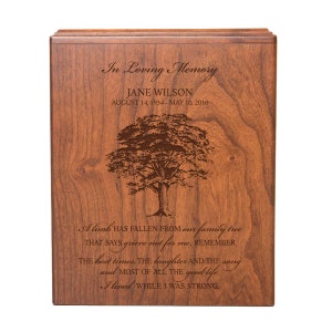 May include: A wooden cremation urn with a tree design and the text "In Loving Memory Jane Wilson August 14, 1934 - May 10, 2010" and a poem about a limb falling from a family tree.