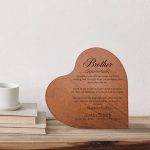 May include: A wooden heart-shaped plaque with a laser-engraved message about a brother. The message reads "I thought of you with love today, but that is nothing new I thought about you yesterday, and days before that too. I think of you in silence, I often speak your name. All I have are memories, and your picture in a frame. Your memory's my keepsake, with which I'll never part. God has you in his keeping, I have you in my heart." The plaque also includes the name "Justin Smith" and the dates "June 18, 1986 - October 22, 2016".