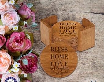 May include: Set of six round wooden coasters with a holder. The coasters are engraved with the text "Bless this home with love and laughter The Avina Family Est. 2020".