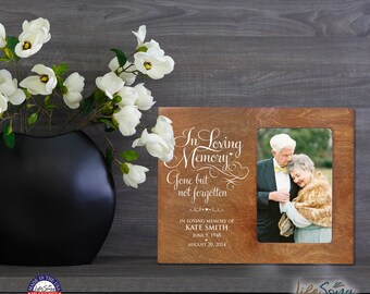 May include: A wooden photo frame with a white inscription that reads "In Loving Memory, Gone but not forgotten." The inscription is followed by the name "Kate Smith" and dates "June 9, 1948" and "August 20, 2014". The frame has a brown wood finish and a photo insert.