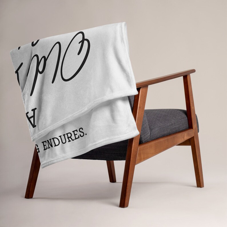 May include: White fleece throw blanket with black text that reads "Everything is going to be okay" and "Love endures."