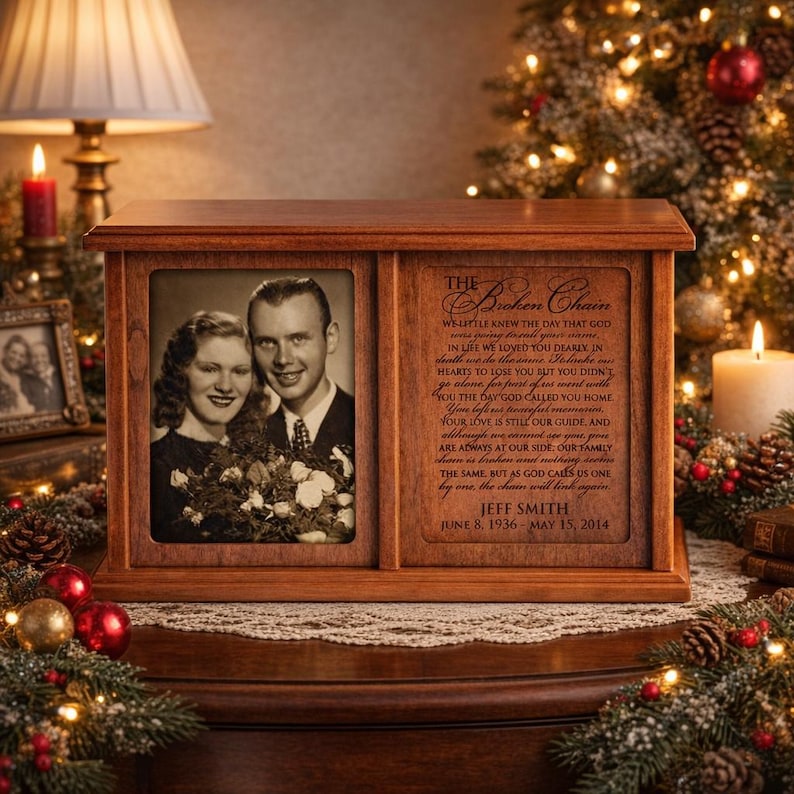 May include: A wooden memorial box with a framed photo of a couple on the left and a poem on the right. The box is brown and sits on a table decorated with Christmas ornaments and lights.