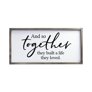 May include: A framed sign with the text "And so together they built a life they loved."