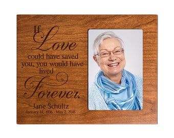 May include: A wooden picture frame with a photo of a woman smiling. The frame has an engraved message that reads "If love could have saved you, you would have lived forever." The frame also includes the name "Jane Schultz" and the dates "January 14, 1936 - May 2, 2018".