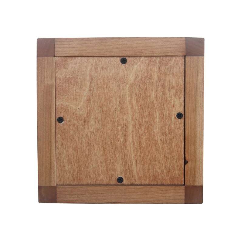 May include: A wooden frame with a light brown wood finish. The frame has a square shape and is made of solid wood. The frame has a smooth surface and is ready to be used for a picture or artwork.