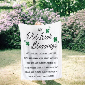 May include: White throw blanket with the text "AN Old Irish Blessings" and a shamrock design. The text continues with "May love and laughter light your days and warm your heart and home. May God and faithful friends be yours where ever you may roam. May peace and plenty bless your world with joy that long endures."