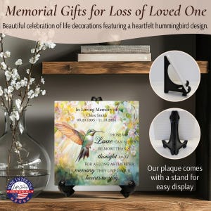 May include: A memorial plaque with a hummingbird design, featuring the text "In Loving Memory of Chloe Smith." The plaque includes a stand for display and is decorated with floral elements. The text reads "Those we love can never be more than a thought away."