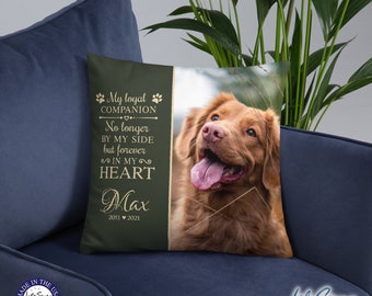 May include: A green and gold memorial pillow with a photo of a golden retriever dog. The text on the pillow reads "My loyal companion, No longer by my side but forever in my heart, Max, 2011-2021".