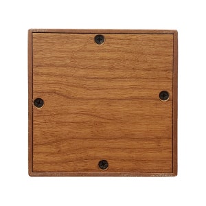 May include: A wooden square box with a brown woodgrain finish. The box has four screws on the front side.