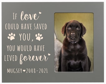 May include: A gray wooden picture frame with a white inscription that reads "If love could have saved you, you would have lived forever."  The inscription also includes two paw prints and a heart. The frame has a 4x6 inch photo opening and a photo of a brown Labrador puppy is in the opening. The inscription at the bottom of the frame reads "Mugsey 2008-2021".