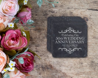May include: Set of six black slate coasters with white text that reads "Celebrating Our 50th Wedding Anniversary Nicole & Drew November 11, 2013".
