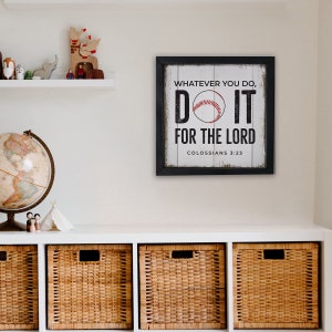 May include: A framed wood sign with a white background and black lettering. The sign features a baseball with red stitching and the text "Whatever you do, Do it for the Lord, Colossians 3:23".