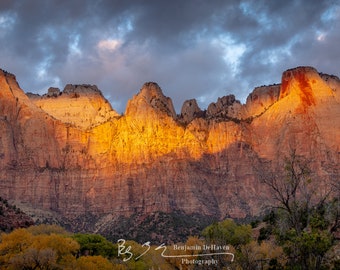 The Towers of the Virgin is an iconic mountain range in Zion National Park. Taken in autumn with golden cottonwood trees.