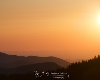 Mountain ridges disappear into the distance during an orange sunset in the Great Smoky Mountains.