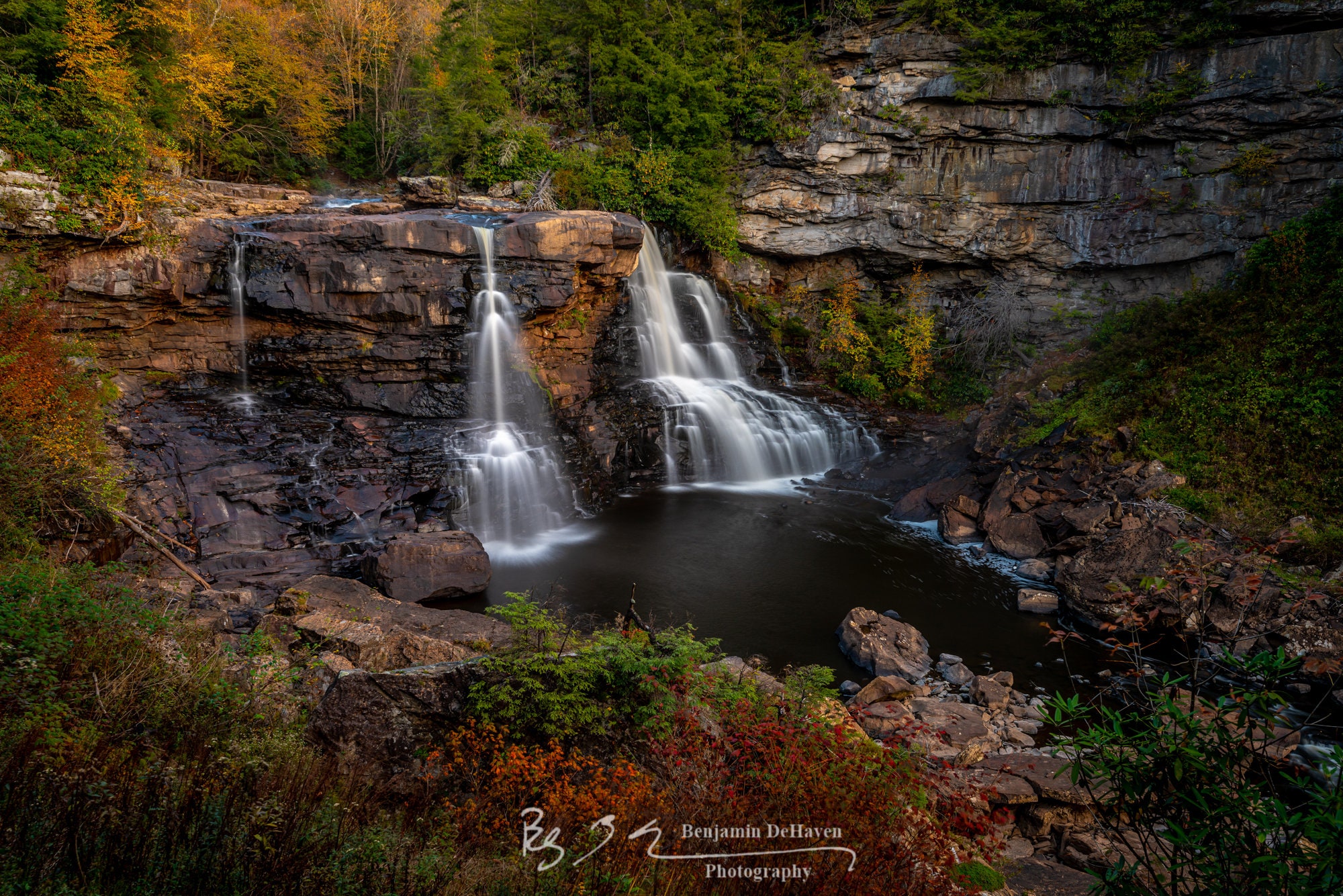 The main waterfall of Blackwater Falls State Park in West Virginia sits like a jewel amongst the autumn leaves and fall foliage.