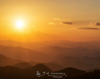 A view from heaven along ridges of the Great Smoky Mountains in Tennessee. A sunset throws shadows through the haze.