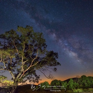 A Milky Way photo of stars blazing over Skyline Drive in Shenandoah National Park at night.