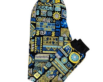 May include: Black leggings with a vibrant, geometric pattern in yellow and blue. The design features various shapes and symbols, with a black cuff at the ankle. The leggings are made of a soft, stretchy material.