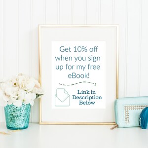 May include: A gold-framed picture with a white background and text that reads "Get 10% off when you sign up for my free eBook!" with a green envelope icon and the text "Link in Description Below".