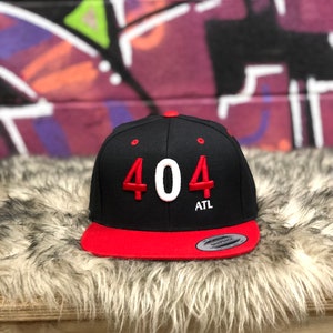 May include: Black and red baseball cap with white embroidered numbers "404" and the text "ATL" on the front.