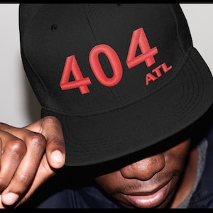 May include: Black baseball cap with red embroidered text "404 ATL" on the front.