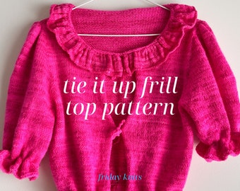 May include: A pink knitted top with a frill collar and cuffs. The top has a tie at the front and the text "tie it up frill top pattern" is written in white on the front. The text "friday knits" is written in blue at the bottom of the image.
