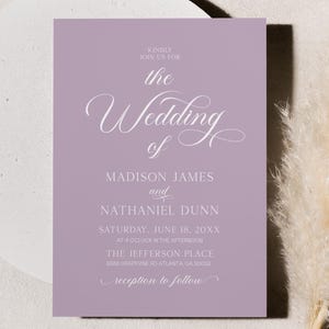 May include: A lavender wedding invitation with elegant script, featuring the words "The Wedding of Madison James and Nathaniel Dunn." The invitation is set against a neutral background with a decorative pampas grass.