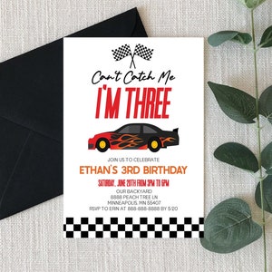 May include: A red and black race car with flames on the side is featured on a birthday invitation. The invitation reads "Can't Catch Me I'M THREE" and includes details for Ethan's 3rd birthday party.