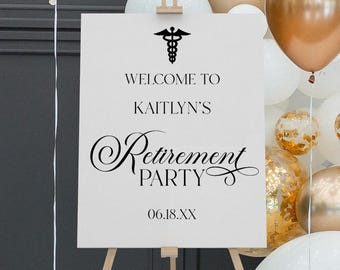 May include: A white rectangular welcome sign on a wooden tripod easel featuring a black caduceus symbol, the text "WELCOME TO KAITLYN'S Retirement PARTY" in a mix of serif and script fonts, and the date "06.18.XX" printed in black ink.