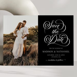 Op de afbeelding: Zwart-wit trouwkaart met de tekst "Save the Date" in elegant schrift. De kaart bevat een foto van een stel en details van de bruiloft, inclusief namen, datum en locatie.
