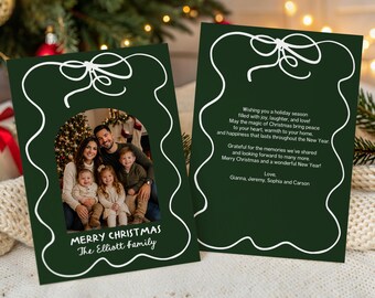 May include: Two dark green holiday greeting cards featuring a white line-drawn bow and scalloped border. The left card displays a family photo with the text Merry Christmas The Elliott Family. The right card contains a printed holiday message.
