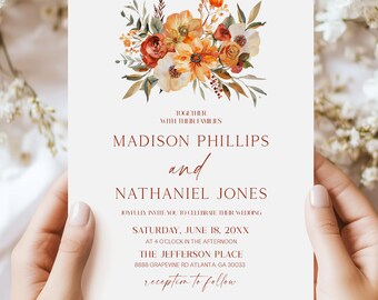 May include: A white wedding invitation card featuring a watercolor floral arrangement in shades of orange, rust, and cream at the top. The text reads: Together with their families, Madison Phillips and Nathaniel Jones, joyfully invite you to celebrate their wedding, Saturday, June 18, 20XX, at 4 o'clock in the afternoon, The Jefferson Place, 8888 Grapevine Rd Atlanta, GA 30033, reception to follow.