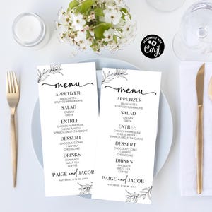 May include: Two black and white wedding menu cards with a floral design. The menu includes appetizers, salads, entrees, desserts, and drinks. The cards are titled "Paige and Jacob" and include the date "Saturday, June 18, 20XX".