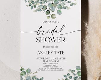 May include: A white bridal shower invitation with a green eucalyptus floral design. The invitation includes the text "Join us for a bridal shower", "In honour of Ashley Tate", "Saturday, June 18th 3PM to 6PM", "Oakley Event Centre 8888 East Blvd Rochester NY 88888", "Registered at Target & Amazon", and "RSVP to Ashley at 888-888-8888 by 6/1".