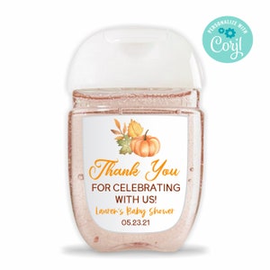 May include: A clear, travel-sized hand sanitizer bottle with a white label featuring a watercolor pumpkin and fall leaves. The label reads "Thank You For Celebrating With Us!" and "Lauren's Baby Shower 05.23.21".