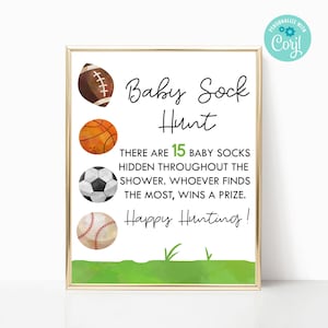 Könnte beinhalten: Ein druckbares Schild mit goldenem Rahmen und grünem Gras Hintergrund. Das Schild sagt "Baby Sock Hunt" und zeigt ein Bild von einem Fußball, Basketball, Fußball und Baseball. Der Text sagt "Es gibt 15 Babysocken, die in der ganzen Dusche versteckt sind. Wer die meisten findet, gewinnt einen Preis. Viel Spaß beim Suchen!"