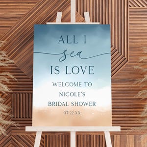 May include: A white ceramic mug with a black handle and the text "But First, Coffee" in a black, handwritten-style font. The mug is on a white surface.