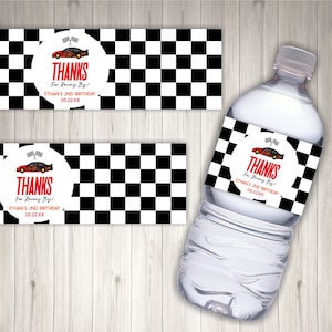 May include: Water bottle label with a checkered black and white background. The label has a red circle with a cartoon race car and the text "THANKS For Racing By! ETHAN'S 2ND BIRTHDAY 05.22.XX"